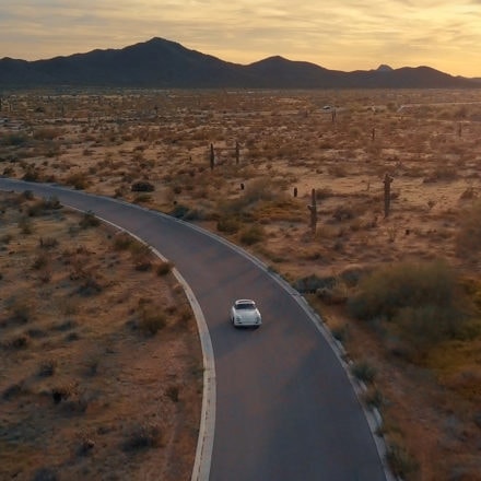 Aerial shot of Bill driving Porsche