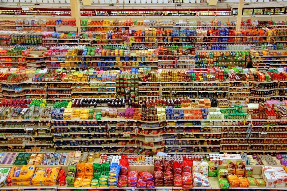 Wide angle photo of grocery aisles taken from a high vantage point.