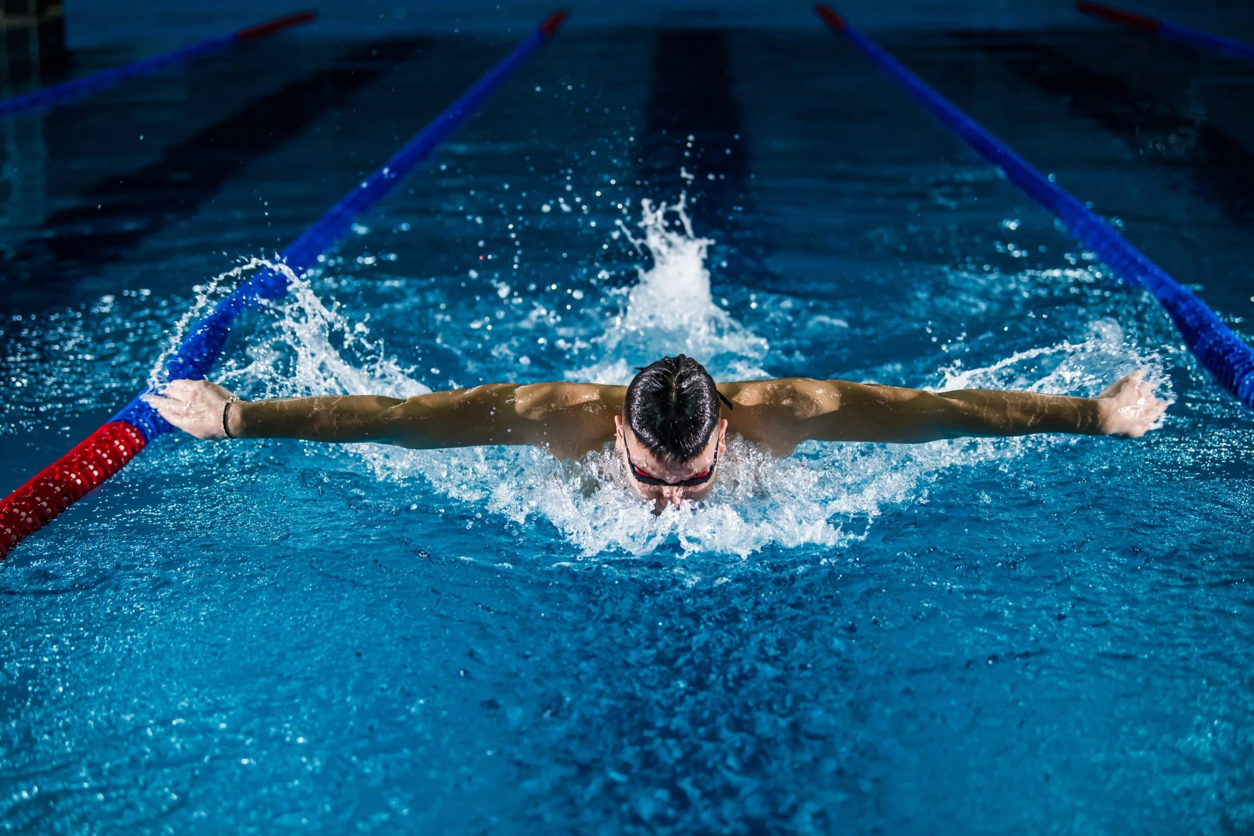 professional swimmer mid stroke in pool